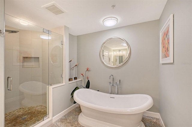 bathroom featuring tile patterned flooring and shower with separate bathtub