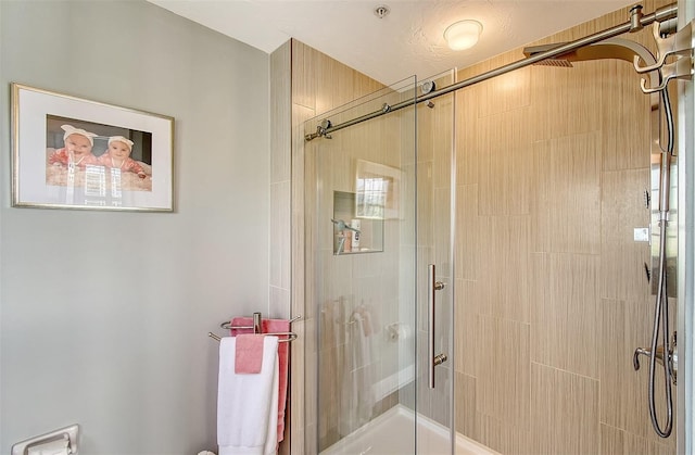 bathroom with a shower with door