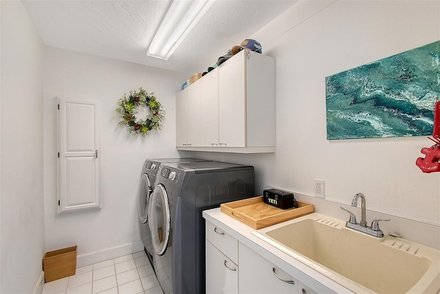 washroom with light tile patterned flooring, cabinets, independent washer and dryer, and sink