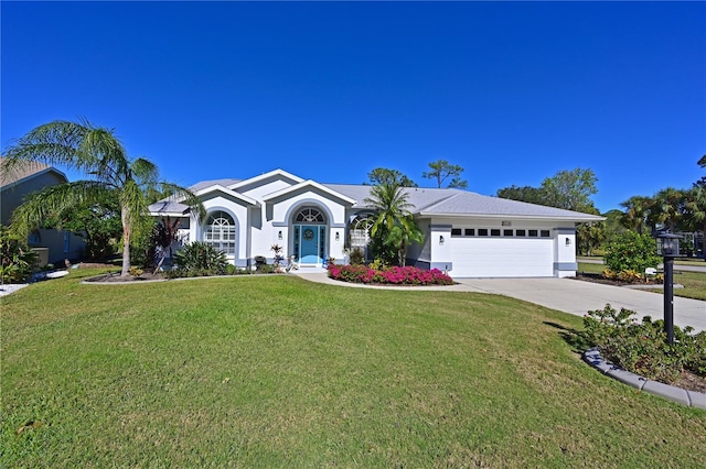 single story home featuring a garage and a front lawn