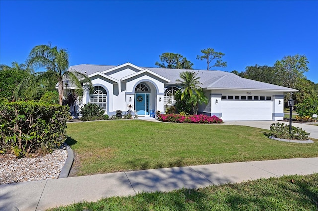 ranch-style house with a front yard and a garage