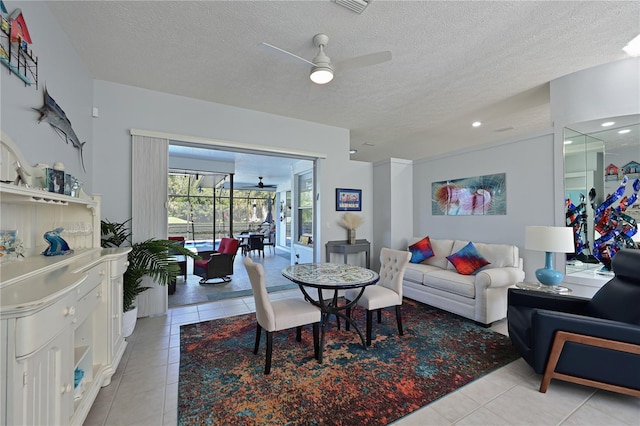 tiled dining room featuring ceiling fan and a textured ceiling