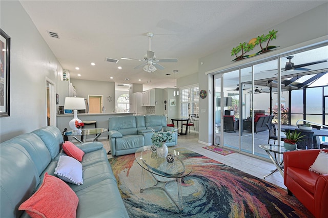 tiled living room with ceiling fan