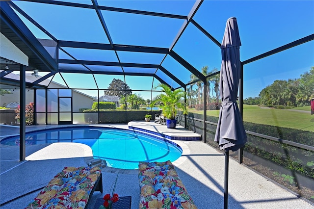 view of swimming pool featuring a patio area and glass enclosure