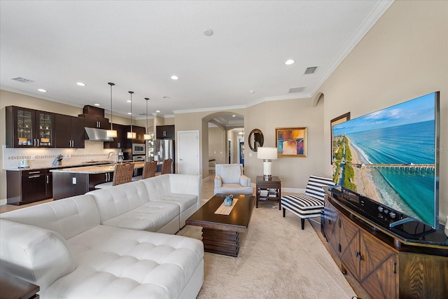 carpeted living room featuring crown molding