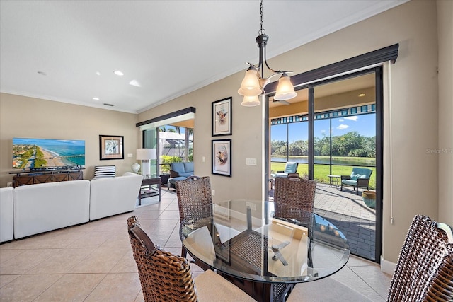 tiled dining space with a notable chandelier and ornamental molding