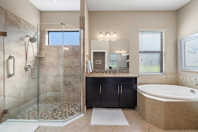 bathroom featuring tile patterned flooring, vanity, and plus walk in shower