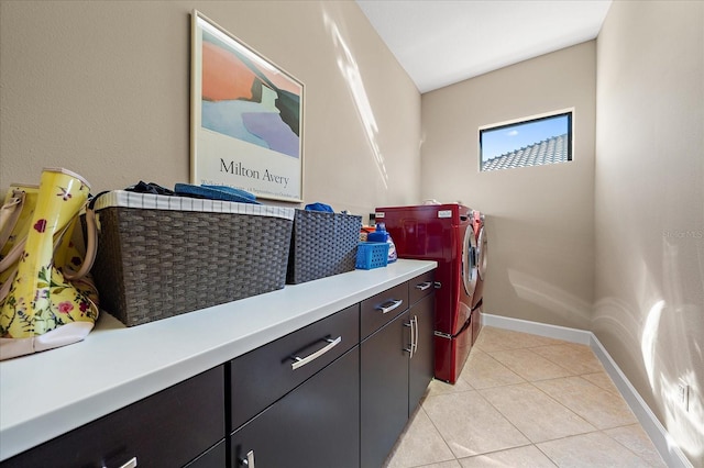 washroom featuring cabinets, independent washer and dryer, and light tile patterned floors