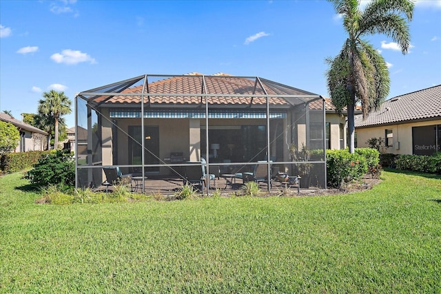 back of house with a lanai and a yard