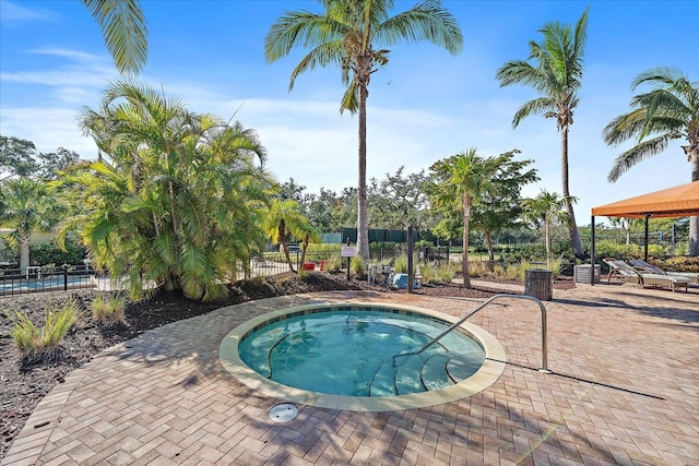 view of swimming pool featuring a community hot tub