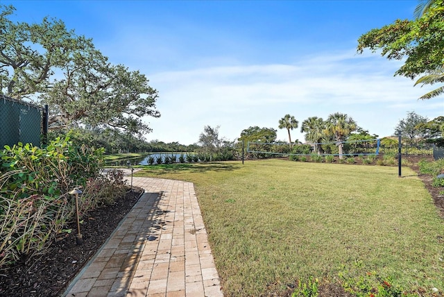 view of yard featuring volleyball court and a water view