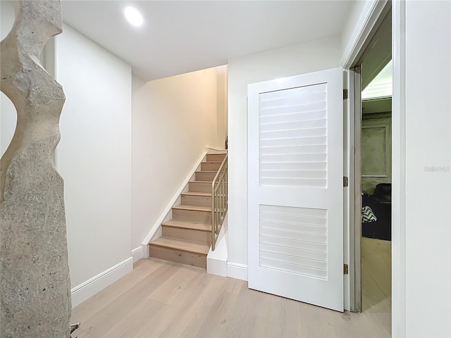 staircase with hardwood / wood-style floors