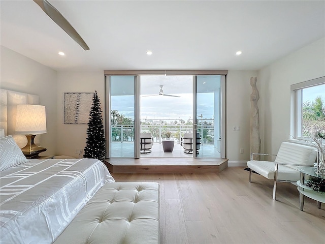 bedroom featuring access to exterior and light hardwood / wood-style flooring