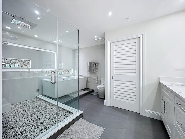 bathroom featuring concrete floors, vanity, a shower with shower door, and toilet