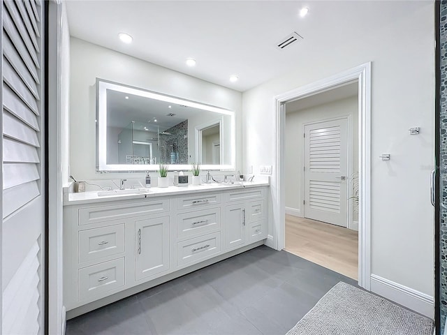 bathroom featuring vanity, wood-type flooring, and a shower with shower door