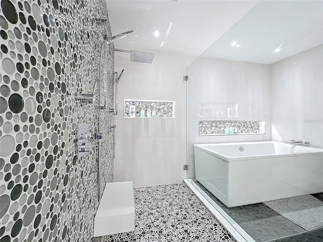 bathroom with shower with separate bathtub