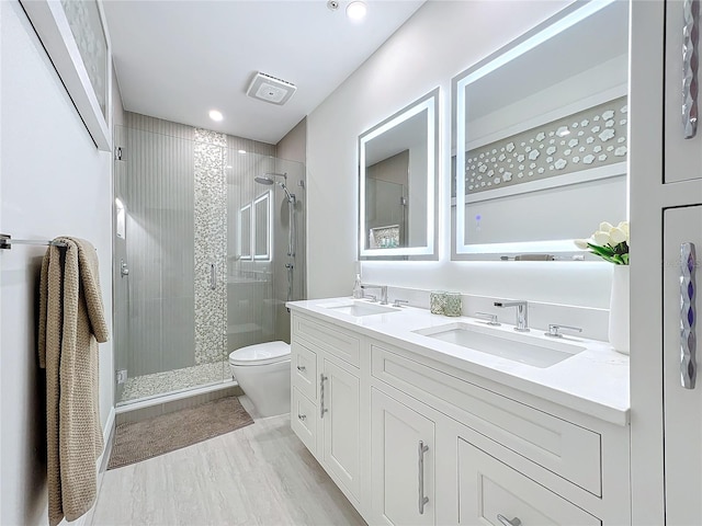 bathroom featuring toilet, vanity, an enclosed shower, and hardwood / wood-style flooring