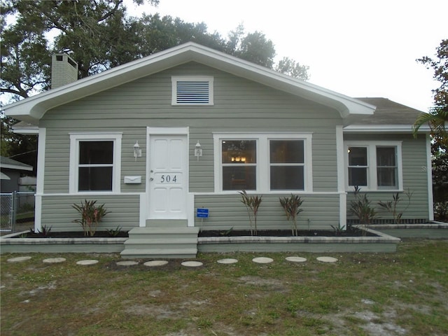 bungalow-style house featuring a front yard