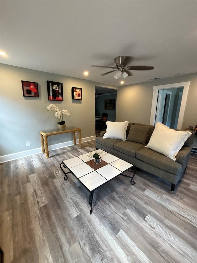 living room featuring hardwood / wood-style flooring and ceiling fan