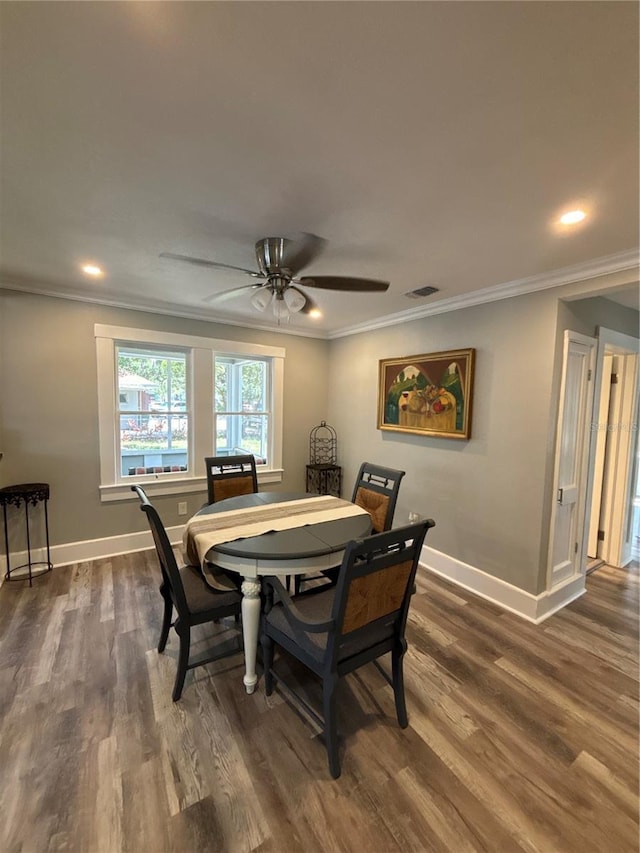 dining space featuring ceiling fan, dark hardwood / wood-style flooring, and ornamental molding