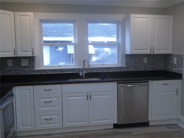 kitchen with dishwasher, white cabinets, plenty of natural light, and sink