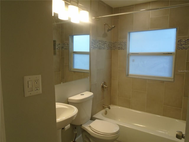 full bathroom with sink, toilet, and tiled shower / bath