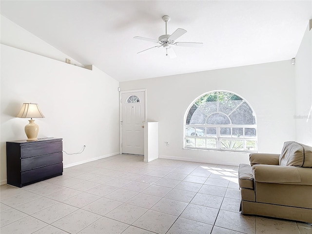 living room with ceiling fan, light tile patterned floors, and lofted ceiling