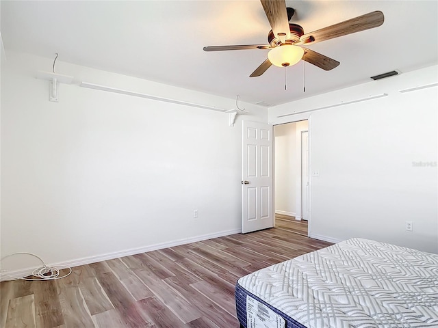 bedroom with light hardwood / wood-style flooring and ceiling fan