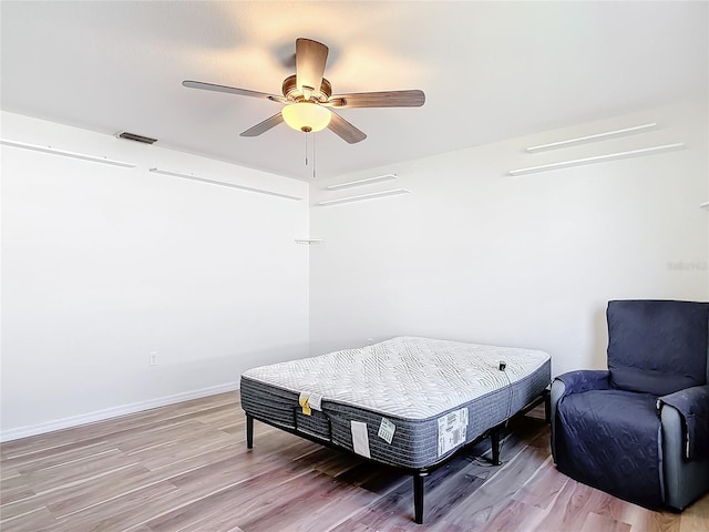 sitting room featuring ceiling fan and hardwood / wood-style floors