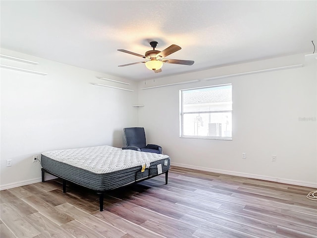 bedroom with light wood-type flooring and ceiling fan