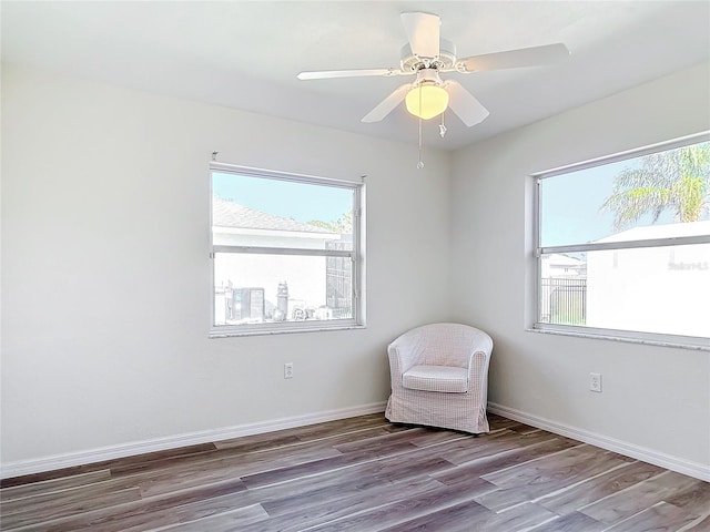 unfurnished room with hardwood / wood-style floors and ceiling fan