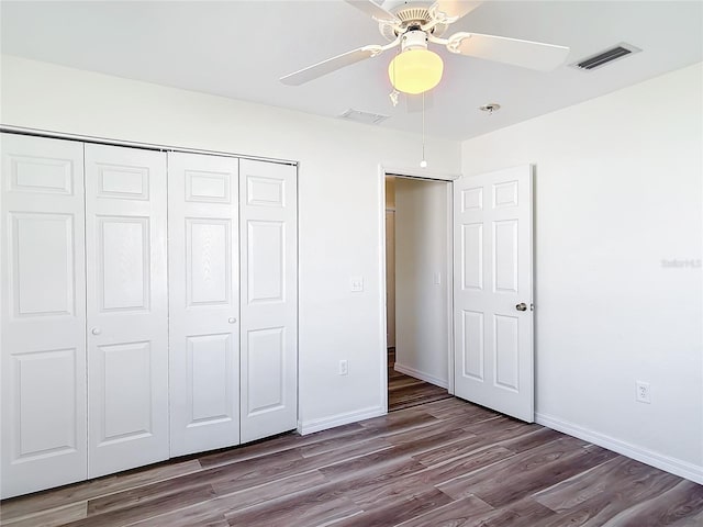 unfurnished bedroom with a closet, hardwood / wood-style flooring, and ceiling fan