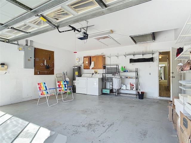 garage featuring washer and dryer, a garage door opener, and electric panel