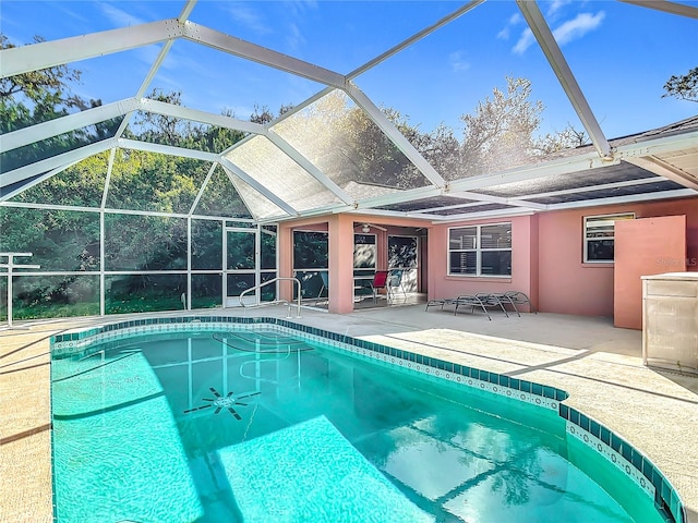 view of swimming pool with glass enclosure and a patio area