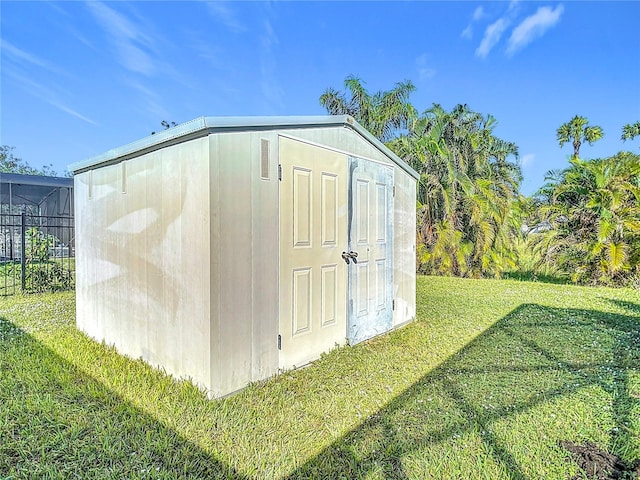 view of outdoor structure featuring a lawn