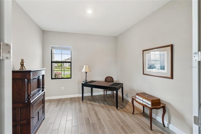 office area featuring light wood finished floors and baseboards