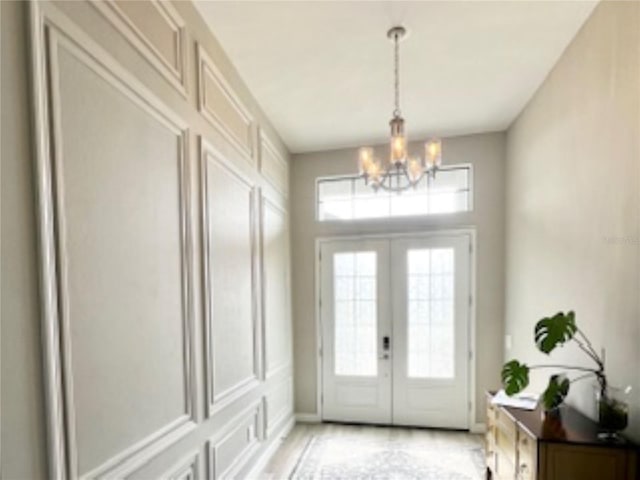 interior space featuring french doors and a notable chandelier