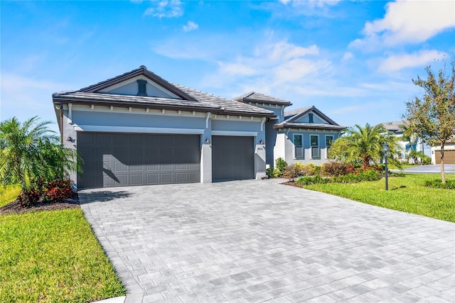 4906 Lighthouse Bay Ln, Bradenton, FL 34211 - view of front of house with decorative driveway, a garage, a front yard, and stucco siding