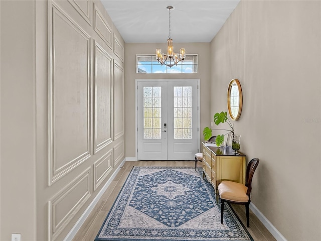 4906 Lighthouse Bay Ln, Bradenton, FL 34211 - foyer entrance with a chandelier, light wood-type flooring, and baseboards