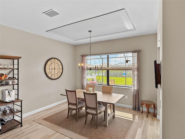 4906 Lighthouse Bay Ln, Bradenton, FL 34211 - dining area with attic access, light wood-style floors, baseboards, and a chandelier