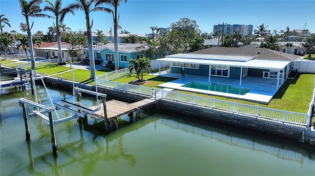 back of house featuring a yard, a water view, and a patio area