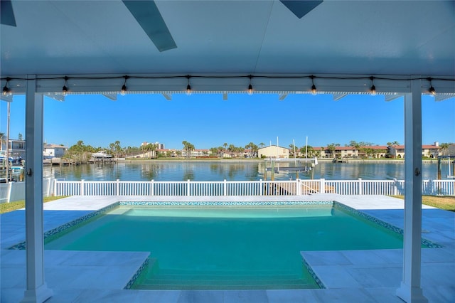 view of pool featuring a water view and a patio