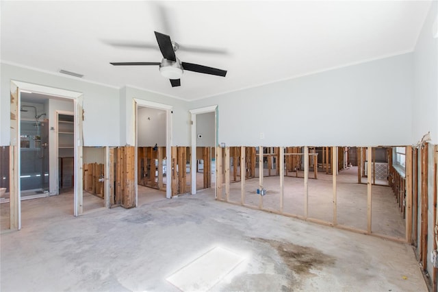 miscellaneous room with ceiling fan, crown molding, and concrete floors