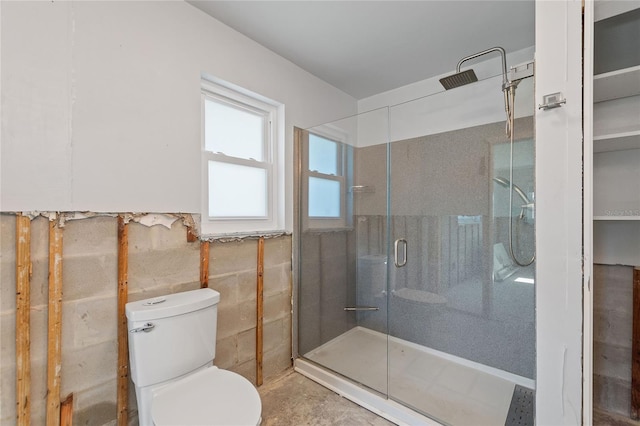 bathroom with toilet and an enclosed shower