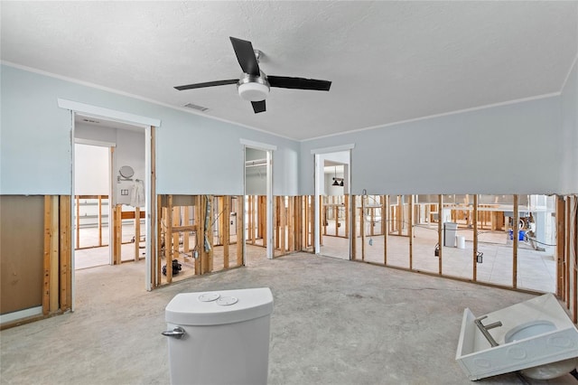 misc room with carpet flooring, ceiling fan, crown molding, and a textured ceiling