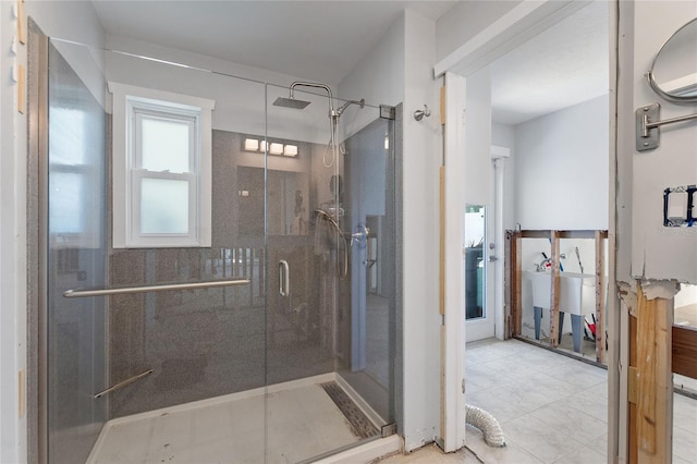 bathroom with tile patterned floors and walk in shower