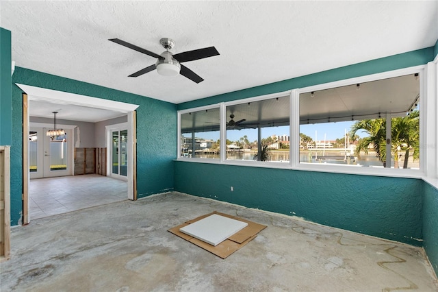 view of patio / terrace with ceiling fan, a water view, and french doors