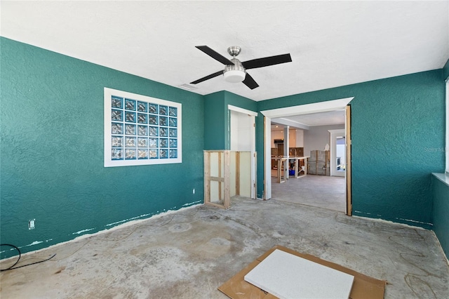 interior space featuring concrete floors and ceiling fan