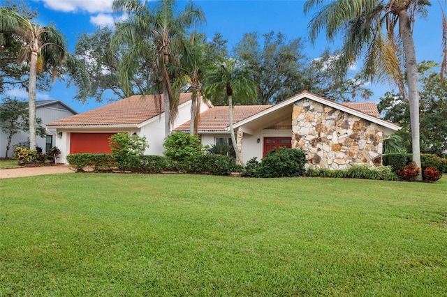 single story home featuring a garage and a front yard