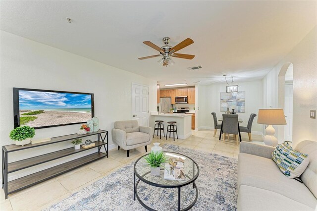 tiled living room with ceiling fan